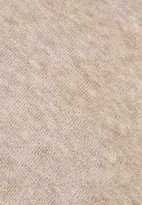 Textured beige fabric with a soft feel, featuring a subtle pattern. Suitable for upholstery or decorative use.