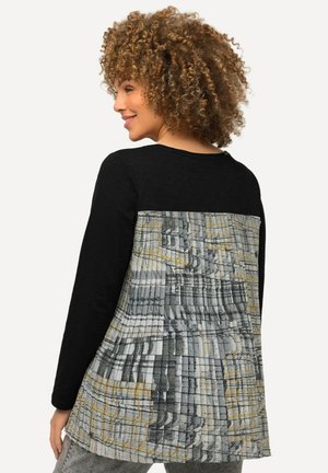 Black long-sleeve top with a textured gray and yellow patterned back. Features a relaxed fit and subtle pleating across the design.