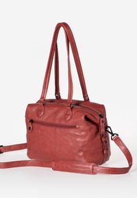Red leather handbag with dual handles and removable shoulder strap. Features a zippered top closure and front pocket with zipper detail.