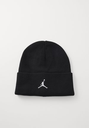 Gorra de punto negra con dobladillo. Presenta un logo Jumpman bordado en blanco en la parte frontal. Textura suave, diseño ajustado.