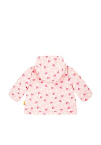 Imperméable rose clair avec capuche, arborant un motif en forme de cœur dans des nuances de rose et de blanc. Texture lisse, manches longues et coupe décontractée.