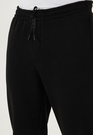 REGULAR FIT - Trainingsbroek - black