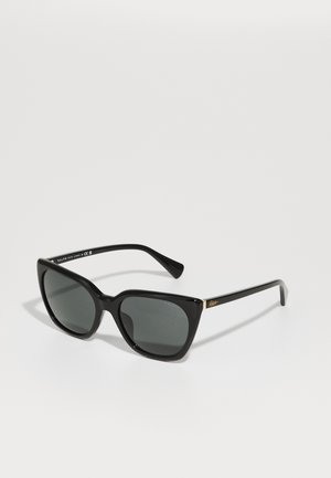 Zwarte cat-eye zonnebril met grijs getinte lenzen, glanzend kunststof frame, gouden accent op de poot en dikke armen.