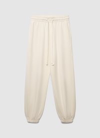 Joggers couleur crème avec une taille élastique, un cordon de serrage ajustable et des poignets élastiques ; tissu lisse avec une coupe décontractée.