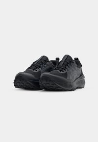Black athletic shoes with a textured rubber sole, reinforced toe, and breathable upper material featuring a subtle logo detail.