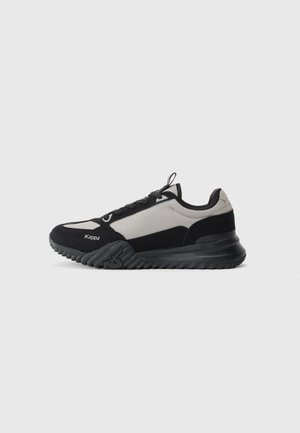 Black and gray low-top athletic sneaker with textured sole, lace-up front, and brand name "Kappa" on the side.