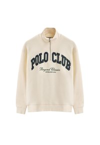 Felpa color crema con mezzo zip realizzata in un tessuto morbido. Presenta la scritta "POLO CLUB" e "Beyond Classics" stampata in testo blu scuro sul petto.