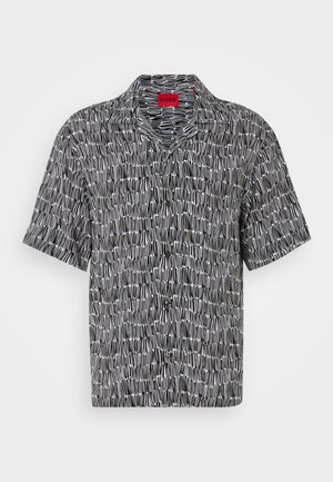 Short-sleeve, black and white patterned shirt with a camp collar and loose fit. Features a geometric design and a red HUGO tag at the collar.