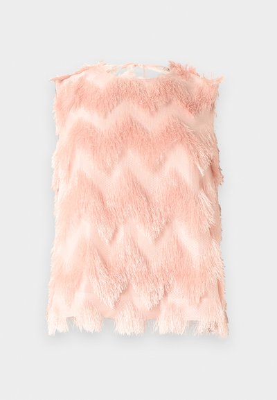 Ροζ αμάνικη μπλούζα με ζικ-ζακ σχέδιο, κατασκευασμένη από απαλό ύφασμα με φράντζες, δεμένη με φιόγκο στο πίσω μέρος του λαιμού.