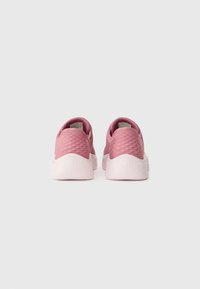 Pink sneakers with a textured upper and smooth sole. Rounded design with low-cut heel and cushioned collar. Features subtle branding on tongue.