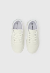 Ténis brancos Calvin Klein com atacadores, vistos de cima sobre um fundo branco, com o tamanho 33 marcado no interior de cada sapato.