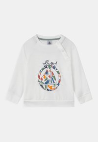 White sweatshirt with long sleeves, featuring a colorful floral design within a circular logo, and two small dogs in an embroidered detail.