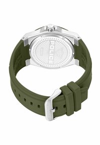 Reloj con correa de silicona verde y caja metálica plateada, logo de la marca embossado, esfera texturizada y forma redonda. Cierre con hebilla ajustable.