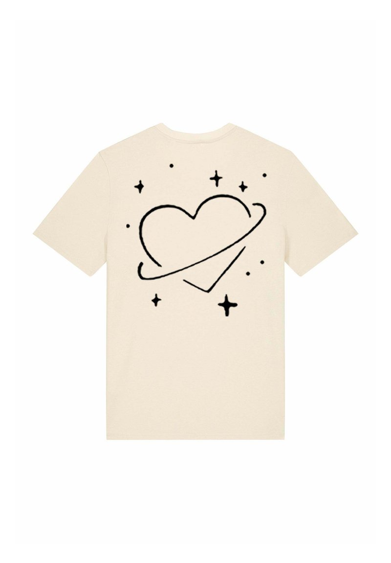 T-shirt beige présentant un graphique de cœur noir entouré d'étoiles et d'un anneau, manches courtes, col rond, en coton doux.