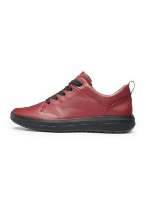 Red low-top leather sneaker with black laces, black sole, and a pull tab at heel, shown in side profile on white background.