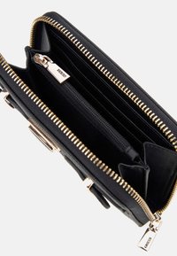 Portafoglio in pelle nera con zip dorata, dotato di molteplici slot per carte, una tasca con zip e un'esterno strutturato. Etichetta del marchio visibile all'interno.