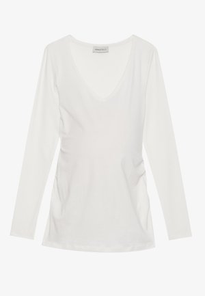 Hvit langermet topp med V-hals, med rynkedetaljer på sidene. Laget av mykt, glatt stoff med et avslappet design.