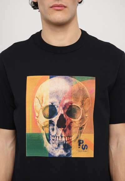 Black cotton t-shirt featuring a colorful skull graphic in the center, with layered shapes in yellow, green, and orange.