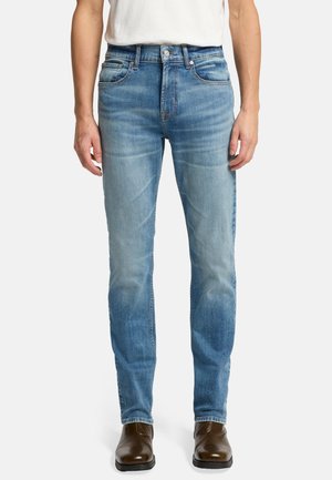 Jeans in denim blu sbiadito con vestibilità slim, dotati di cinque tasche, zip sul davanti e leggere sfumature sulle cosce. Decorati con cuciture a contrasto.