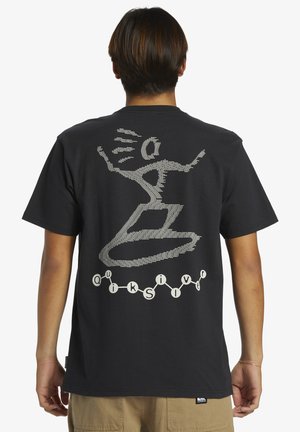Black cotton t-shirt featuring a large white graphic print on the back, depicting abstract figures and text in a dynamic design.