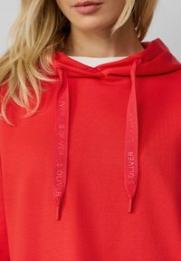 Rode sweatshirt met capuchon, voorzien van bijpassende trekkoorden met de opdruk "SOLIVER," gemaakt van zachte stof, geschikt voor casual kleding.