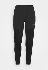 Pantalones deportivos negros con cinturilla elástica, corte entallado y una capa texturizada. Presenta un pequeño logo de Nike en el lado izquierdo.