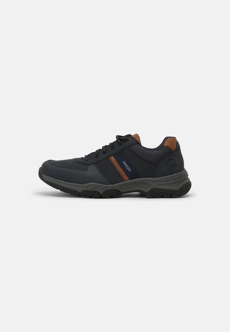 Men's navy athletic shoes with a textured fabric upper, brown accents, and a chunky black rubber sole. Features prominent lacing and logo.