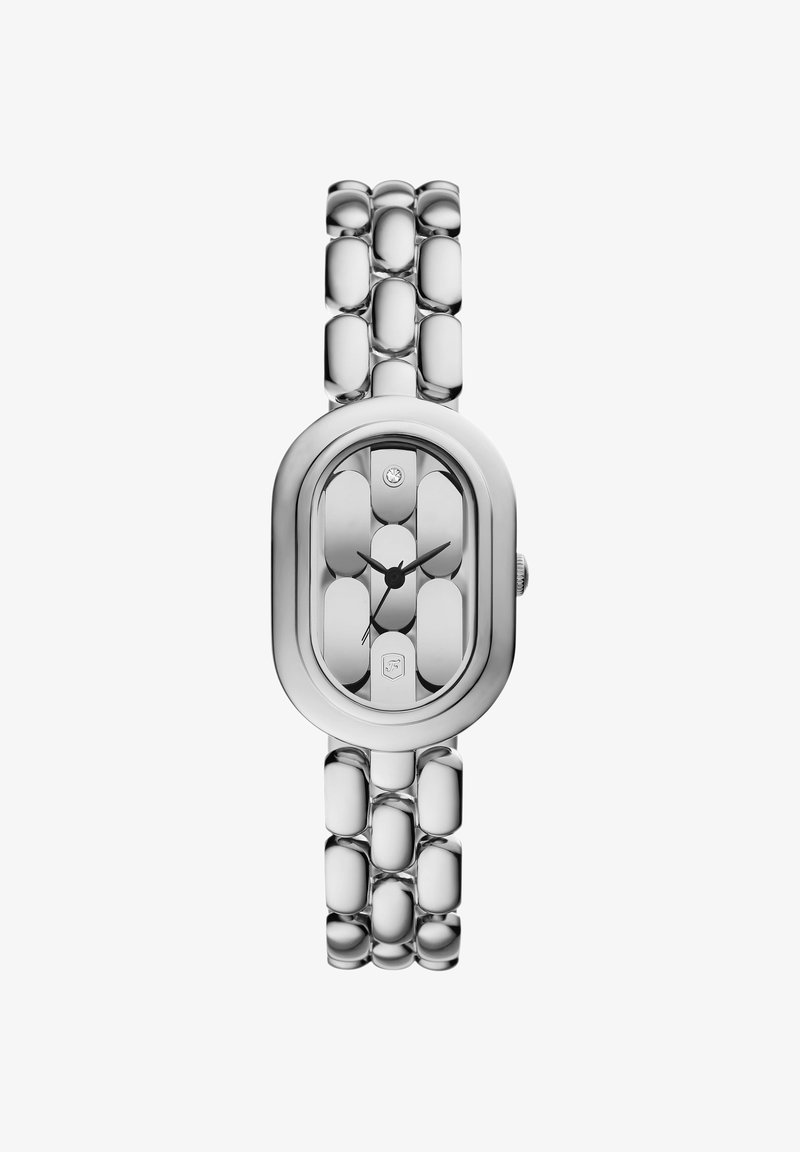 Montre-bracelet ovale argentée avec un bracelet à maillons, aiguilles noires des heures et des minutes, et un petit détail en diamant à l’intérieur du cadran.