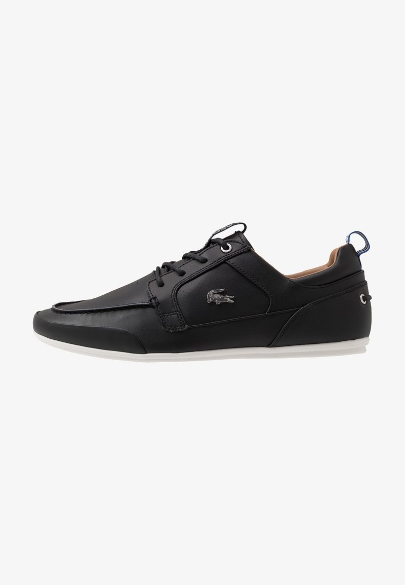 Black leather sneaker with a smooth finish, contrasting white sole, minimal stitching, logo detail on the side, and lace-up design.