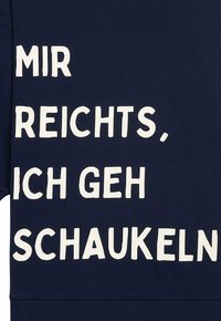 Navyblaues Sweatshirt mit großem weißem Text, der "MIR REICHTS, ICH GEH SCHAUKELN" liest. Weicher Stoff mit lockerer Passform.