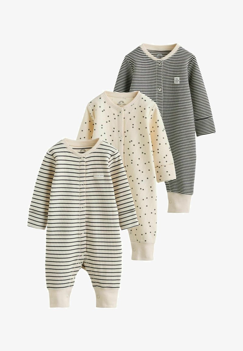Trois grenouillères bébé à manches longues avec fermetures pression ; deux rayées noir et crème, une crème avec motif étoiles noires, jambes et col avec poignets.
