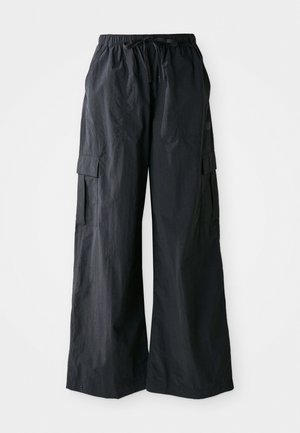 Black cargo pants made of lightweight fabric, featuring a wide leg design, elastic waistband, and multiple side pockets. Simple and functional.