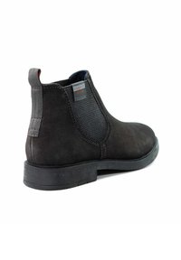 Schwarze Wildleder-Ankle Boots mit elastischen seitlichen Einsätzen, Gummisohle und einer Zuglasche hinten. Verfügt über eine strukturierte Oberfläche und subtile Akzentnähte.