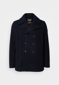 Marineblaue Woll-Peacoat mit einem doppelt geknöpften Design, großem Reverskragen und zwei vorderen Taschen. Mit schwarzen Knöpfen und Schulterpatch.