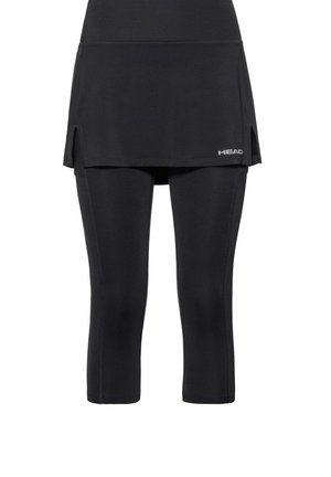 Leggings atléticos negros con falda adjunta que presenta aberturas laterales y un pequeño logo "HEAD" en la parte frontal inferior derecha.
