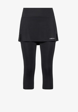 Leggings atléticos negros con falda adjunta que presenta aberturas laterales y un pequeño logo "HEAD" en la parte frontal inferior derecha.