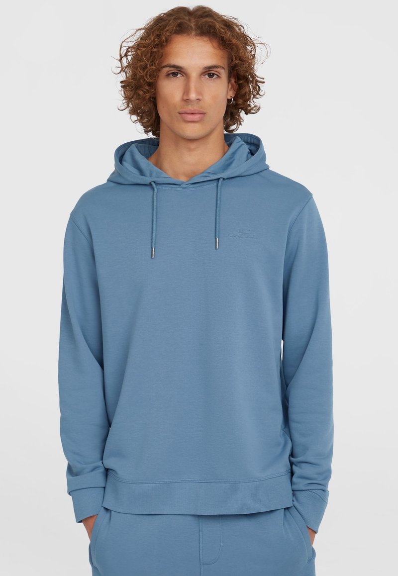 Light blue hoodie made from soft fabric, featuring a drawstring hood, ribbed cuffs, and a small embossed logo on the chest.