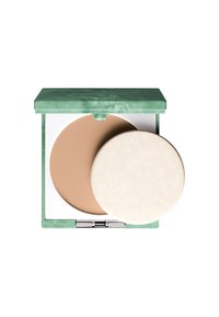 Poudre compacte dans un étui marbré vert. Contient une poudre brun clair avec une texture nervurée et un applicateur rond et doux en mousse blanche.