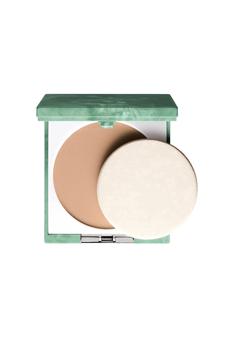 Poudre compacte dans un étui marbré vert. Contient une poudre brun clair avec une texture nervurée et un applicateur rond et doux en mousse blanche.