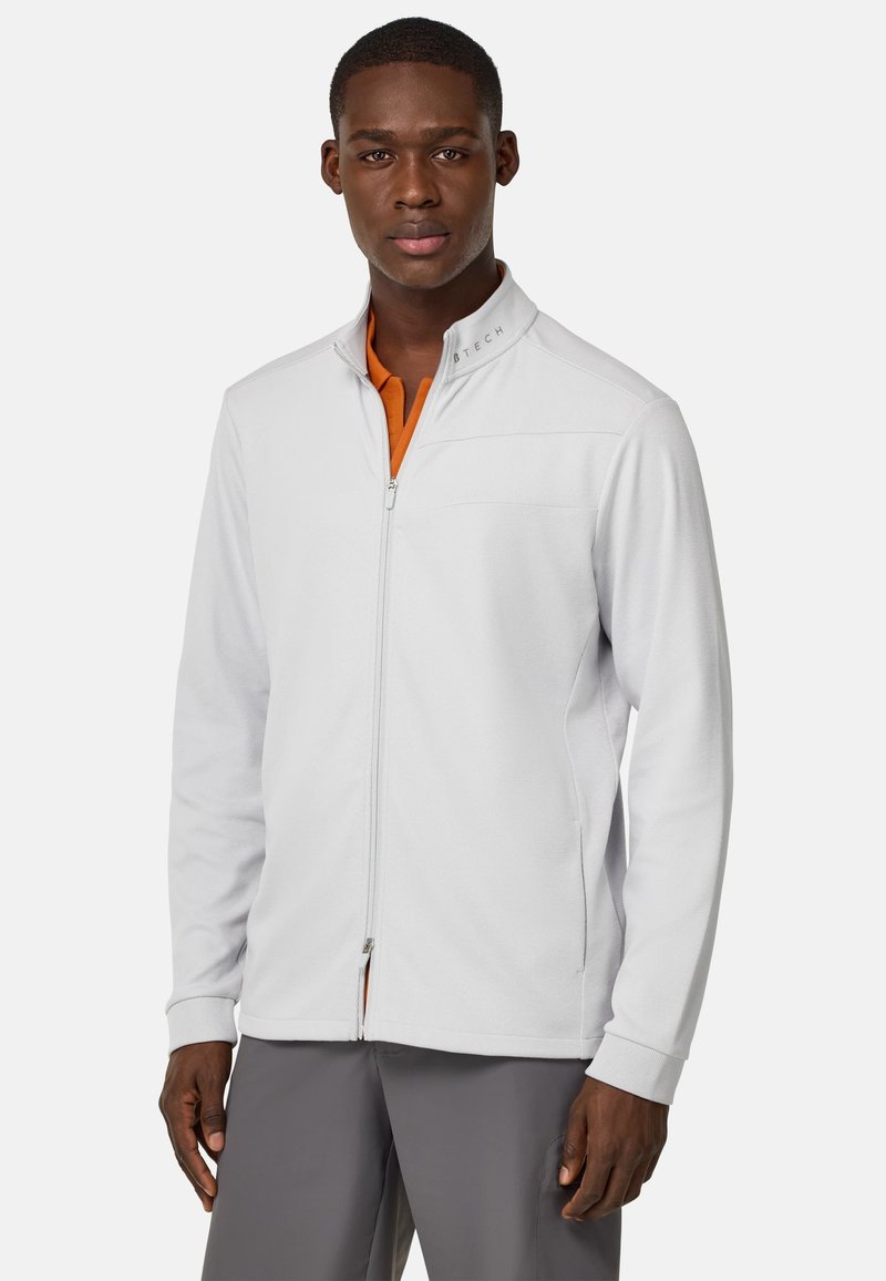 Chaqueta de color gris claro con cremallera, patrón texturizado, cuello alto y un interior naranja en contraste. Presenta un bolsillo en el pecho y puños acanalados.