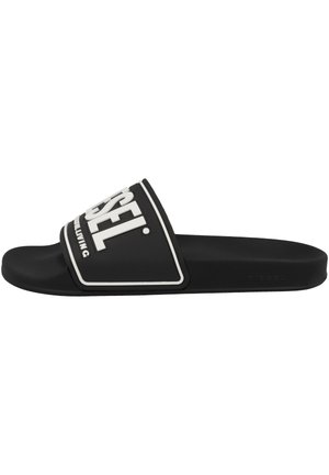 Sandale à enfiler noire avec logo Diesel blanc sur large bride et semelle intérieure profilée pour un port décontracté.