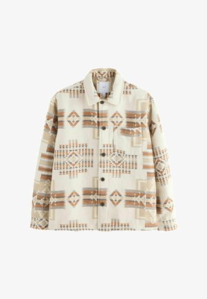 Beige színű, geometrikus mintázatú dzseki narancssárga, barna és szürke színnel. Gombos elülső rész és klasszikus gallér jellemzi. Puha szövet érzet.