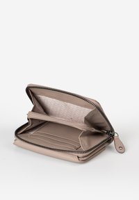 Beige zippered wallet with leather exterior, multiple card slots, an inner zip pocket, and a soft fabric lining featuring a geometric pattern.