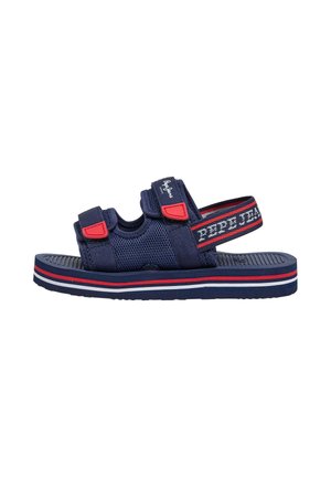 Sandalia azul marino con puntera abierta y correas ajustables en rojo y azul marino, tejido de malla y suela a rayas en blanco, rojo y azul marino.