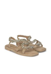 Sandali piatti beige con design a catena adornati con strass. Texture in morbida suede, apertura sulla punta e silhouette con fascette.