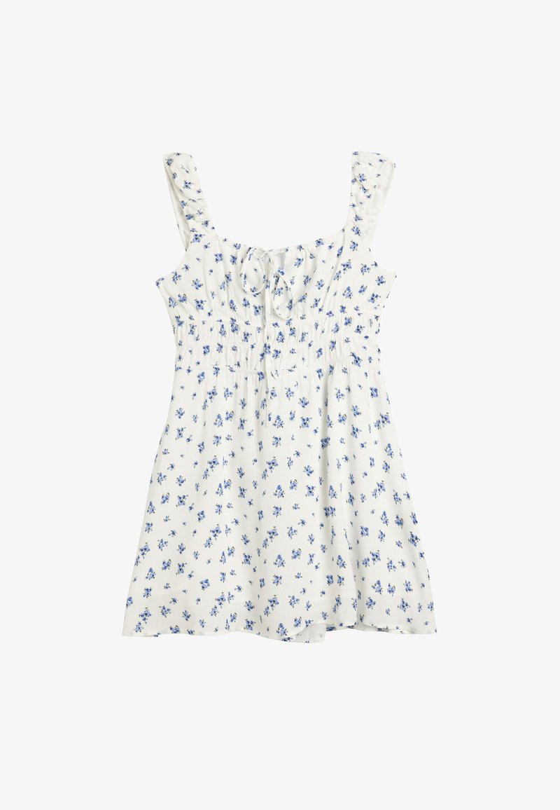 Valkoinen mekko sinisillä kukkakuvioilla, jossa on solmittava etuosa, neliönmallinen kaula-aukko ja röyhelövarret. Valmistettu kevyestä kankaasta, jossa on rento istuvuus.