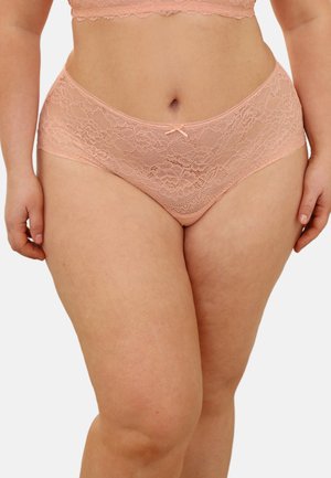 Lace peach-colored high-waist underwear and matching bra on a plus-size person, showing torso and upper thighs against a plain background.