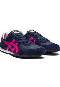 Navy blue athletic shoes with pink accents, suede and textile materials, rounded shape, lace-up design, and a textured black sole.
