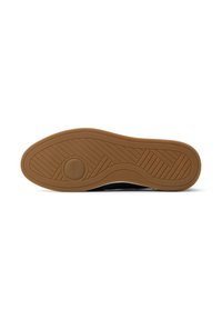 Black shoe sole with a textured, patterned surface; made of rubber with a light brown gum sole showing a circular logo and tread design.