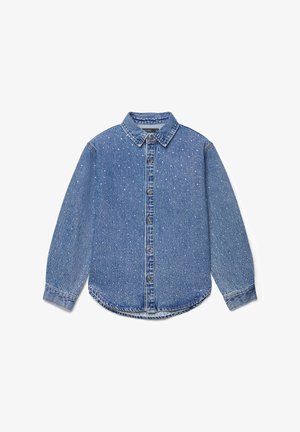 Chemise en denim bleu à manches longues avec col et boutons sur le devant, présentant un petit motif à pois blancs et des poignets boutonnés.